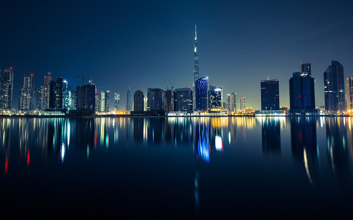 Dubai skyline at night reflected in the water